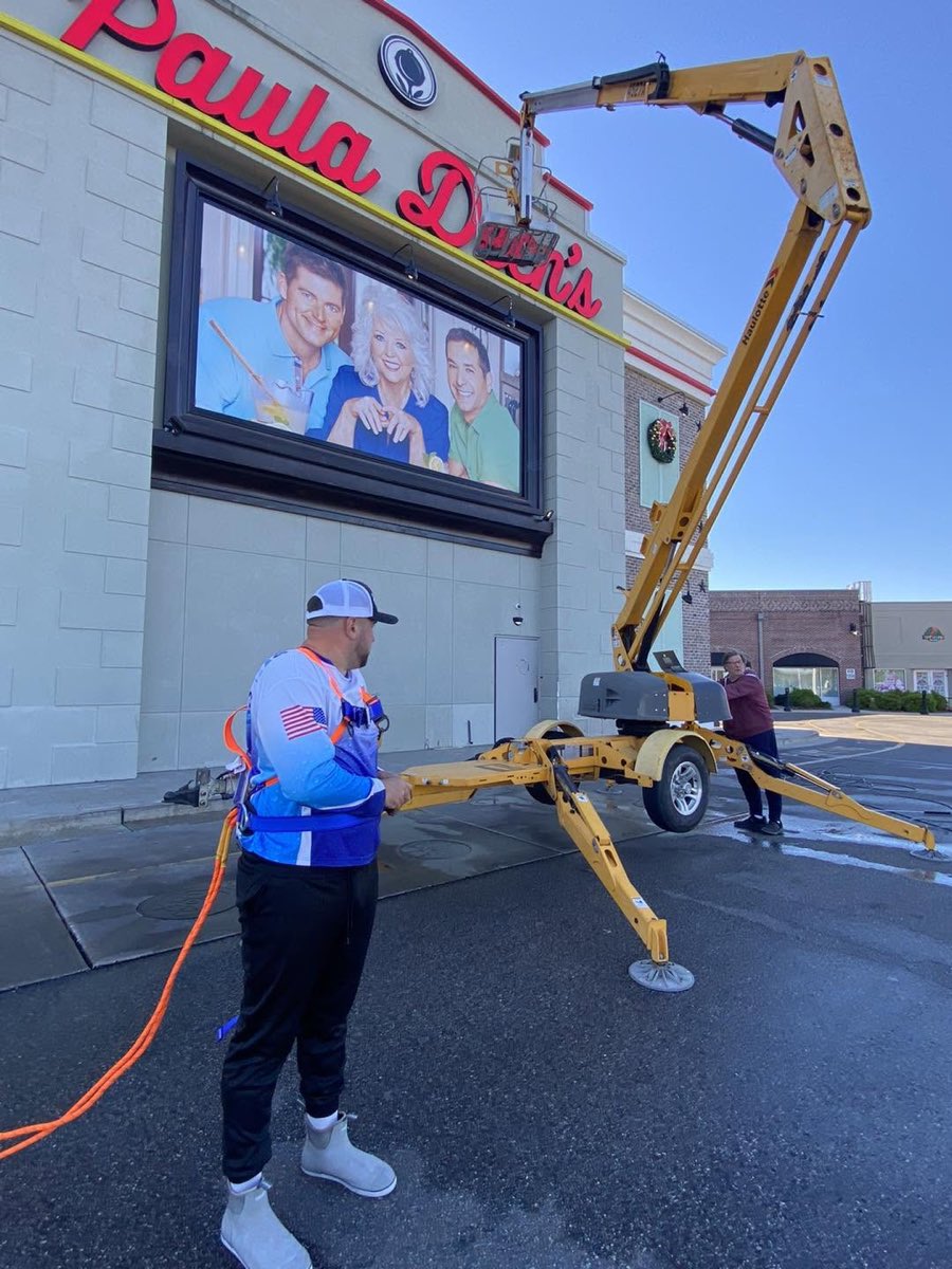 Power Suds washing a restaurant exterior from a boom lift