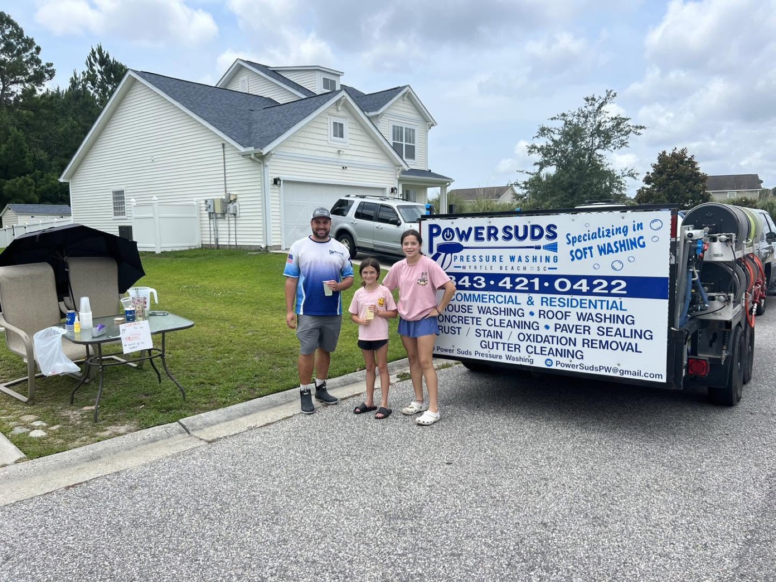 The Power Suds team with their fully equipped soft-wash trailer